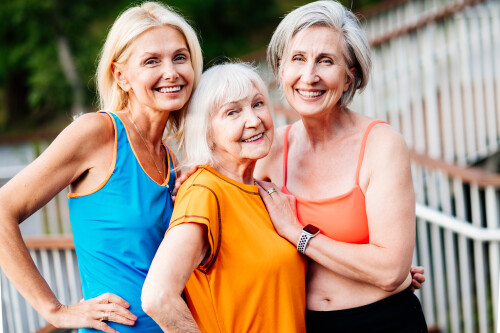 Group of beautiful sportive senior women training outdoors - Mature adults old friends doing fitness workout exercises in a park to stay healthy and fit
